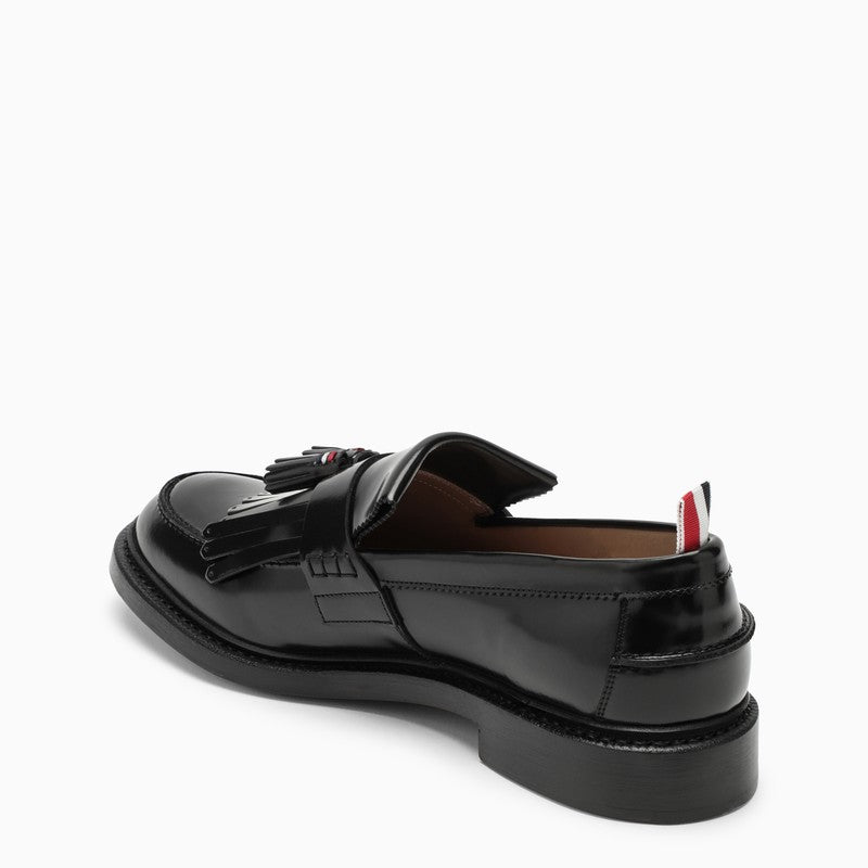 Black leather moccasin with tassels