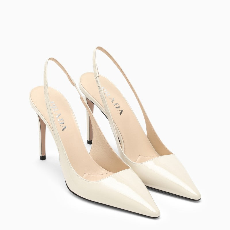 Pointed ivory patent leather slingback pumps